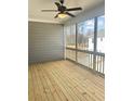 Relaxing screened porch boasts wood flooring, a ceiling fan, and views of the outdoors at 3350 Cranston Ln, Kennesaw, GA 30144