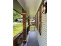 Covered front porch with dark grey floor, metal railing, and decorative lighting perfect for relaxing outdoors at 3640 Narron Dr, Atlanta, GA 30331