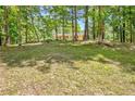 Beautiful home nestled in a wooded lot offering lots of shade and privacy from the surrounding trees at 4950 Creel Rd, Chattahoochee Hills, GA 30213