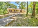 Charming yellow house featuring a spacious covered front porch perfect for enjoying the outdoors at 4950 Creel Rd, Chattahoochee Hills, GA 30213
