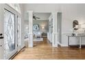 Elegant foyer showcasing hardwood floors, decorative pillars, an ornate glass front door, and a view to the living room at 5105 Deerlake Dr, Alpharetta, GA 30005