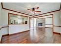Spacious living room with hardwood floors, white brick fireplace, and open floorplan at 606 Evergreen Dr, Woodstock, GA 30188