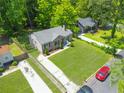 Aerial view of a well-kept house with green lawns and driveway at 2115 Pinehurst Dr, East Point, GA 30344