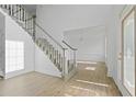 Bright foyer with wood-look floors, staircase, and a glimpse into the formal living area at 327 Awendaw Cir, Ellenwood, GA 30294