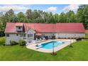 Aerial view of backyard features an in-ground pool, deck, and well-maintained lawn at 425 Chadwick Pl, Canton, GA 30114