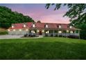 Beautiful exterior view of home with a red roof and inviting front porch at twilight at 425 Chadwick Pl, Canton, GA 30114