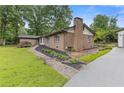 Brick home featuring an attached garage and brick pathway at 679 Creek View Dr, Lawrenceville, GA 30044