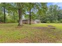Large yard with mature trees surrounding the brick home at 679 Creek View Dr, Lawrenceville, GA 30044