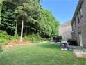 Spacious backyard featuring a lush lawn, mature trees, and a cozy gazebo, perfect for outdoor gatherings at 3389 Rosecliff Trce, Buford, GA 30519