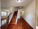 Bright entryway showcasing hardwood floors and staircase leading to the second floor at 3389 Rosecliff Trce, Buford, GA 30519