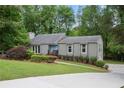 Charming single-story home with a landscaped front yard and inviting blue door at 3006 Alberta Dr, Marietta, GA 30062