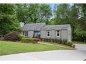 Charming home with grey siding, blue front door, mature landscaping, and driveway at 3006 Alberta Dr, Marietta, GA 30062