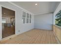 Covered wooden porch showcasing views of the kitchen and neighborhood at 3338 Cranston Ln, Kennesaw, GA 30144