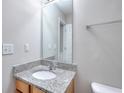 Neutral powder room features a granite countertop, undermount sink, and chrome faucet at 4041 Ash Tree St, Snellville, GA 30039