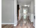 Inviting foyer features hardwood floors, neutral paint and molding leading into the home's living spaces at 4041 Ash Tree St, Snellville, GA 30039