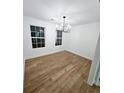 Light-filled dining room with hardwood floors and modern chandelier at 681 Burtons Cv, Hampton, GA 30228