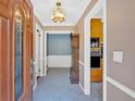 Inviting foyer with a decorative door, traditional grandfather clock, and views into adjacent rooms at 124 Chaseland Rd, Atlanta, GA 30328