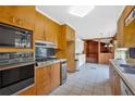 Functional kitchen features wood cabinets, stainless steel appliances, and an adjacent room for added space at 124 Chaseland Rd, Atlanta, GA 30328