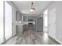 Stylish eat-in kitchen featuring stainless steel appliances and sleek gray cabinetry at 145 Silver Mine Trl, Austell, GA 30168