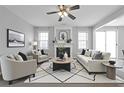 Comfortable living room featuring a cozy fireplace, a ceiling fan, and neutral tones at 145 Silver Mine Trl, Austell, GA 30168
