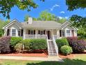 Beautiful single-Gathering home showcasing a white porch, manicured front yard, and attractive landscaping at 148 Paradise Xing, Douglasville, GA 30134