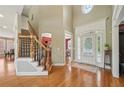 Stunning foyer with hardwood floors, staircase, and elegant doorway leading into the home at 2871 Trailing Ivy Way, Buford, GA 30519