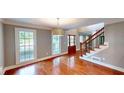 Bright foyer with hardwood floors, staircase, and stylish light fixture at 1477 Triple Creek Nw Ct, Kennesaw, GA 30144