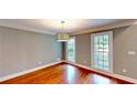 Cozy living room featuring hardwood floors and natural light from large windows at 1477 Triple Creek Nw Ct, Kennesaw, GA 30144