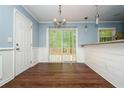 Bright dining area with hardwood floors and sliding glass doors leading to outdoor deck at 3372 Ward Drive Southwest Sw Dr, Atlanta, GA 30354