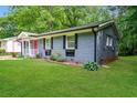 Lovely view of the home's side exterior, with a well-maintained lawn and landscaping at 3372 Ward Drive Southwest Sw Dr, Atlanta, GA 30354