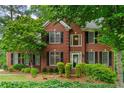 Beautiful brick two-story home with black shutters and lush green landscaping at 3642 Fowler Rdg, Douglasville, GA 30135