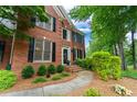 Elegant brick home with black shutters, a paved walkway, and meticulously maintained landscaping at 3642 Fowler Rdg, Douglasville, GA 30135