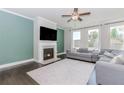 Cozy living room featuring a fireplace, hardwood floors, and plenty of natural light at 431 Hinton Farm Way, Dacula, GA 30019