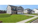 Beautiful two-story home featuring a well-maintained lawn and an attached two car garage at 637 Kimberwick Dr, Locust Grove, GA 30248