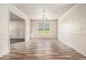 Light-filled dining room featuring decorative molding, neutral walls, and hardwood-style floors at 9066 Bob Jackson Dr, Jonesboro, GA 30238