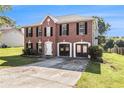 Brick two-story home with a two-car garage and classic design on a lush green lawn at 9066 Bob Jackson Dr, Jonesboro, GA 30238