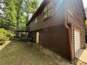 View of the rear exterior featuring a wood facade and garage at 2685 Hyde Cir, Duluth, GA 30096