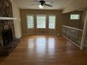 Open living area with a stone fireplace and hardwood floors at 2685 Hyde Cir, Duluth, GA 30096