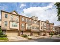 Street view of brick townhomes showcasing well-maintained landscaping and consistent architecture at 275 Blue Pointe Ct, Suwanee, GA 30024