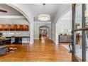 Grand foyer with hardwood floors, arched doorways, a round chandelier, and views into other rooms at 504 S Westminster Ne Way, Atlanta, GA 30307