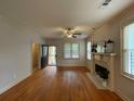 Inviting living room featuring a fireplace, hardwood floors, and ample natural light, ideal for relaxation and comfort at 937 Capitol View Nw Ave, Atlanta, GA 30318