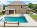 Incredible backyard showcasing a large pool, hot tub, patio, with ample space for outdoor entertaining and relaxation at 132 Shellbark Dr, Mcdonough, GA 30252