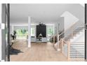 Bright foyer with hardwood floors, modern staircase, and an open-concept view into the living room and dining area at 1610 Niskey Lake Rd, Atlanta, GA 30331