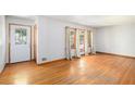 Bright living room with gleaming hardwood floors, large windows, and decorative front door at 2595 Woodhill Cir, Atlanta, GA 30344