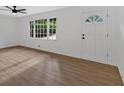 Bright, spacious living room with hardwood floors and a front door at 5689 Woodland Dr, Acworth, GA 30102