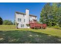 Backyard with a multi-level deck, a large grassy area, and mature trees at 6645 Crest Wood Ln, Douglasville, GA 30135