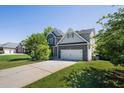 Beautiful home featuring stone accents, double garage, and mature landscaping at 6645 Crest Wood Ln, Douglasville, GA 30135