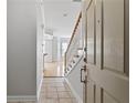 Entryway with tiled floor leading to hardwood floors and staircase with white railing at 850 Piedmont Ne Ave # 3304, Atlanta, GA 30308