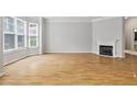 Living room with hardwood floors, a fireplace, and large windows providing natural light at 850 Piedmont Ne Ave # 3304, Atlanta, GA 30308