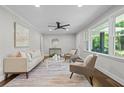Well-lit living room features hardwood floors, neutral paint, ceiling fan, and large windows at 3180 Rehoboth Dr, Decatur, GA 30033